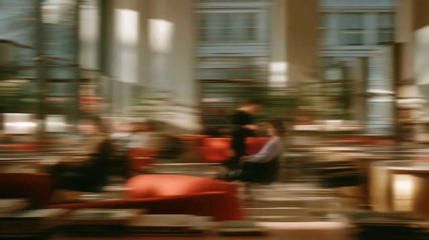 Blurred guests and staff crossing a warm hotel lounge